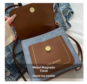 Detail of magnetic snap closure on vintage patchwork crossbody bag with logo lettering