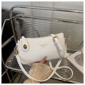 Detail of white litchi pattern leather crescent bag with golden Fashion Bag text logo