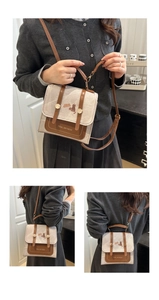 Detail of vintage canvas and brown leather crossbody bag with cat illustration and strap