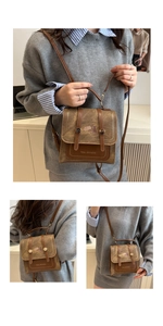 Detail view showing brown vintage canvas crossbody bag with cat patch and logo