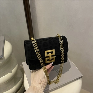 Chic black leopard print crossbody bag with gold geometric clasp and chain strap