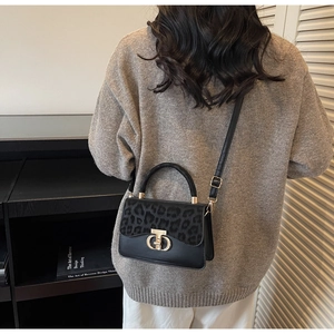 Rear view of a model wearing the leopard print crossbody bag with metal ring detail