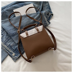 Detail of vintage mini backpack with brown faux leather and grey suede patchwork design
