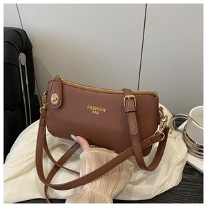 Brown litchi grain leather crossbody bag with gold Fashion Bag print and zipper closure