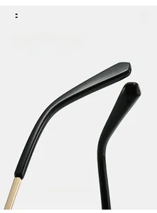 Detail of ergonomic curved black glasses legs with golden metal hinge accents