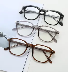 Close-up of retro polygonal optical frames in black, translucent grey, and dark amber colors