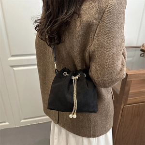 Retro black frosted suede bucket bag with gold chain drawstring and pearl accents