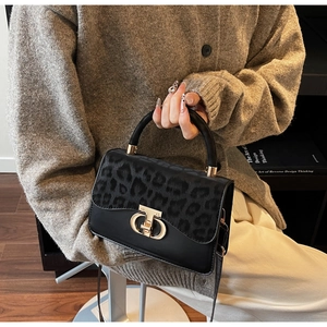 Detail of leopard print flap handbag with gold metal twist lock and smooth leather