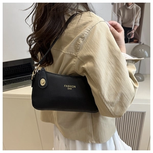 Detail of black lychee leather bag featuring a gold zipper and Fashion Bag logo