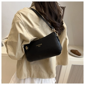 Close-up of black lychee grain leather shoulder bag with gold metal zipper and logo