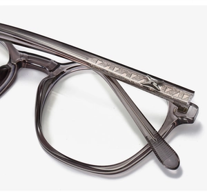 Macro detail of retro grey transparent glasses frame featuring metal geometric temples