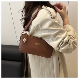 Brown leather underarm bag featuring a gold turn-lock closure and elegant logo detail