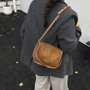 Vintage caramel brown suede crossbody bag styled with a grey blazer and trousers