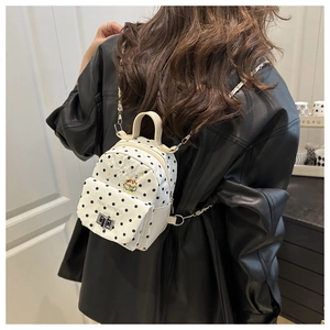 Polka dot mini backpack featuring embroidered burger detail and sleek metal chain strap