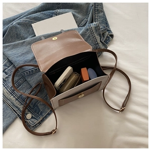 Interior view of the contrast shoulder bag showing space for a wallet and phone