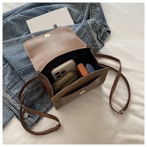 Detailed interior of a vintage mini crossbody bag showing storage capacity for phone and items