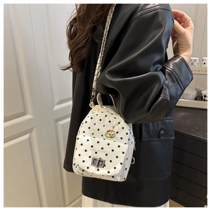 Polka dot mini backpack featuring hamburger embroidery and metal chain straps on model