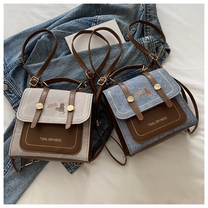 Flat lay of retro canvas and denim crossbody bags with cat prints and leather flaps