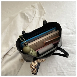 Top view of a large black leather tote bag showing spacious interior with multi-compartments
