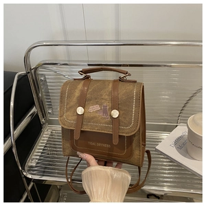 Close-up of retro brown canvas bag with Tidal Dryness cat pattern and leather flap