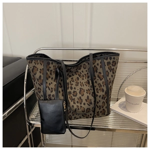 Detail of leopard print tote bag with small black detachable pouch on a stylish shelf