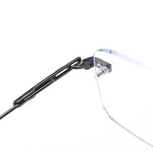Detail view of rimless glasses featuring black metal double-line temples and sturdy hinges