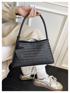 Close-up of black woven tote bag texture with thick braided handle for women