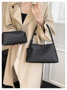 Close-up of black woven shoulder bag and clutch featuring premium leather braiding texture
