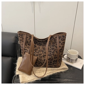Detail view of leopard print tote bag with matching mini pouch and brown faux leather straps