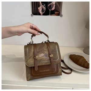 Close-up of retro brown canvas bag with cat illustration and stylish leather straps