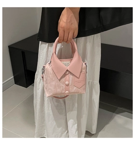 Detailed view of a unique pink shirt-style handbag with decorative collar and buttons
