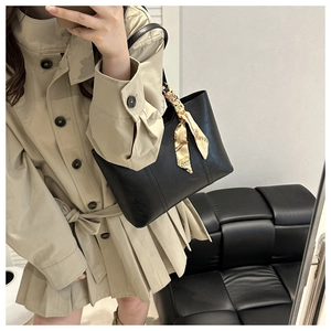 Black PU leather tote bag with elegant champagne silk scarf shown in a mirror selfie view