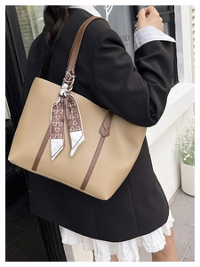 Detailed side view of khaki PU leather tote bag with printed silk scarf on shoulder