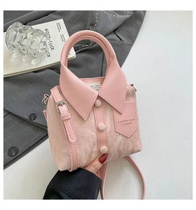 Detail of pink crossbody bag with shirt collar design and adjustable shoulder strap