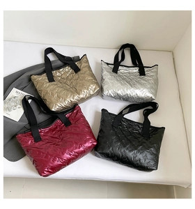 Quilted tote bag detail showing metallic colors with embossed bow patterns and woven handles