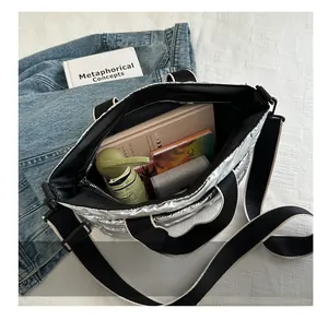 Internal view of silver puffer bucket bag showing spacious storage for daily items