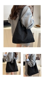 Detail of minimalist black suede tote bag showing soft texture and spacious commuter design