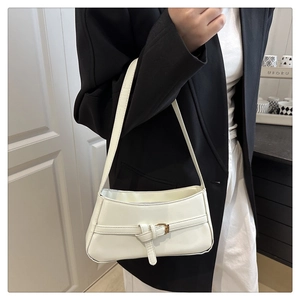 Minimalist white faux leather underarm bag with decorative buckle shown on model