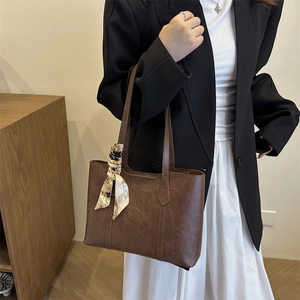 Vintage dark brown leather tote bag with silk scarf accessory for commuting style