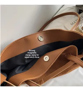 Macro detail of the brown leather tote bag showing the strong magnetic clasp closure