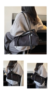 Three-way view of a large black suede-like tote bag showing capacity and on-shoulder styling