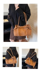 Close-up of brown faux suede tote bag featuring smooth leather straps and large capacity