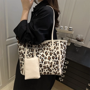 Large leopard print canvas tote bag with white faux leather handles and small pouch