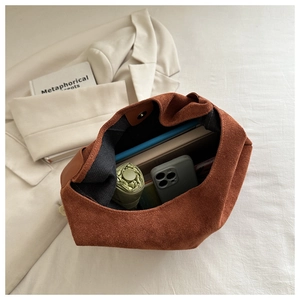 Spacious caramel suede tote bag interior showing capacity for an umbrella and phone