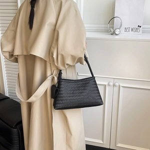 Large black woven shoulder bag with intricate Intrecciato pattern for everyday style