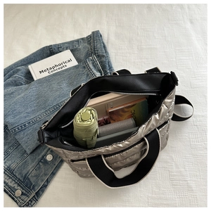 Spacious interior of quilted tote bag showing umbrella, books and gadgets storage
