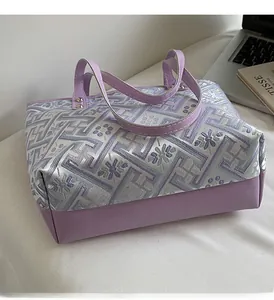 Detailed view of lavender jacquard tote bag with geometric patterns and leather handles