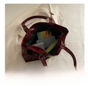 Top view of spacious burgundy tote interior showing high capacity for daily items