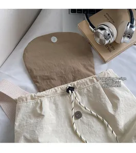 Detail of nylon backpack drawstring closure with adjustable buckle and magnetic snap button