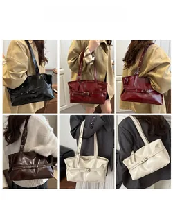 Detail view of glossy patent leather tote bags with metal eyelet straps and buckles